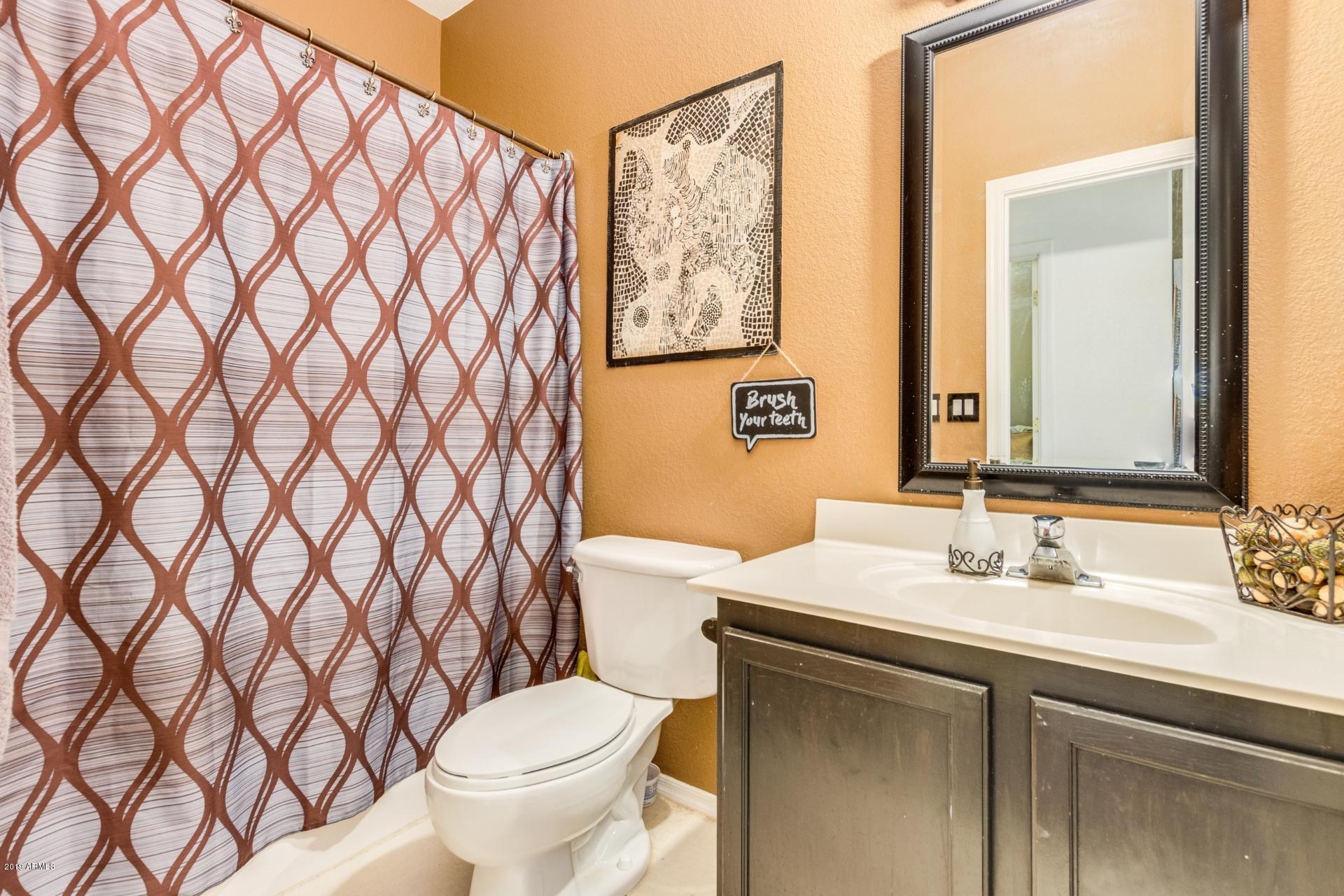 10434 East Bonnell Street Apache Junction, AZ 85120 - Photo 16 of 21 a bathroom with a sink toilet and a mirror