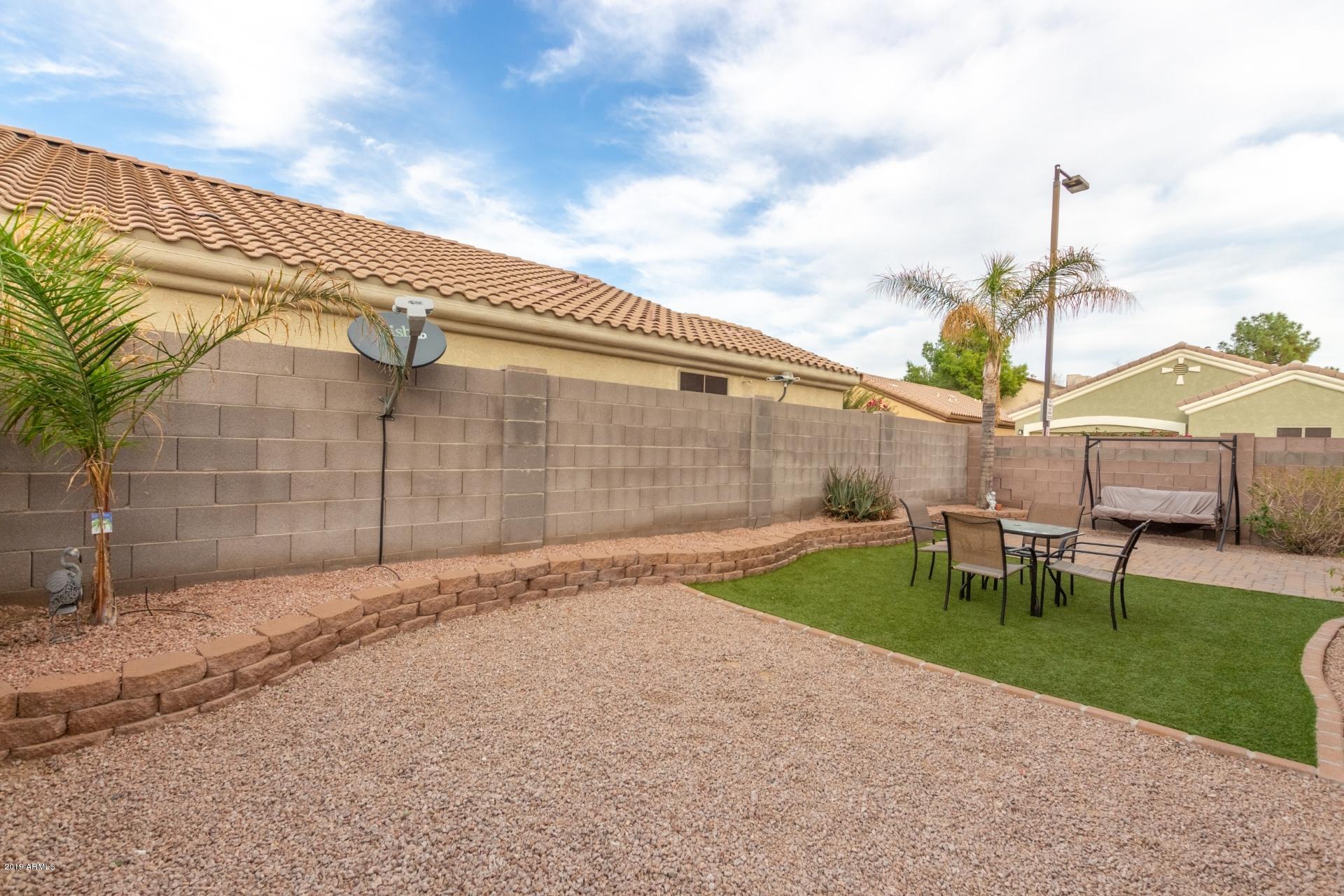 10434 East Bonnell Street Apache Junction, AZ 85120 - Photo 20 of 21 a backyard of a house with table and chairs