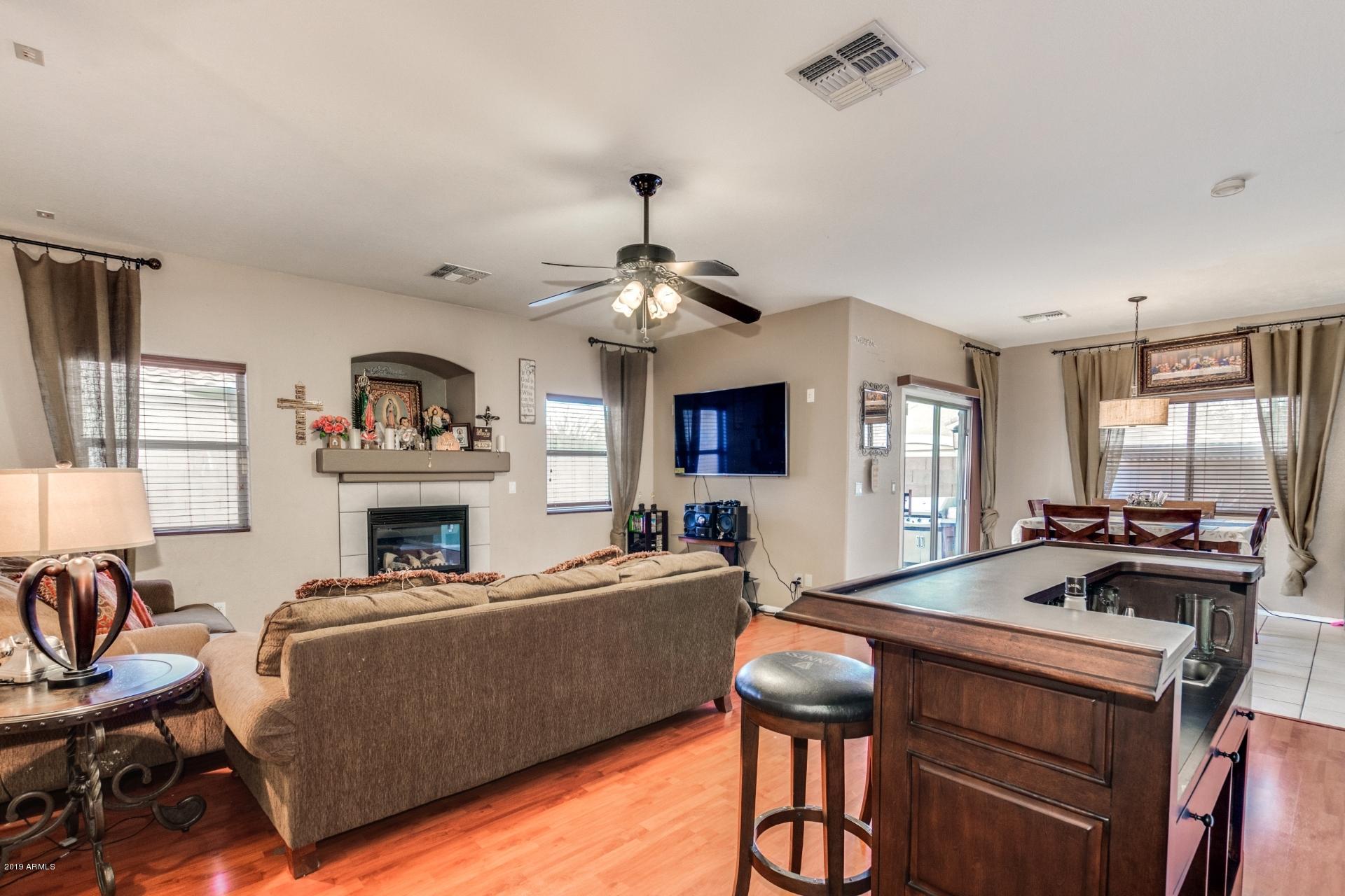 10434 East Bonnell Street Apache Junction, AZ 85120 - Photo 5 of 21 a living room with furniture fireplace and a window