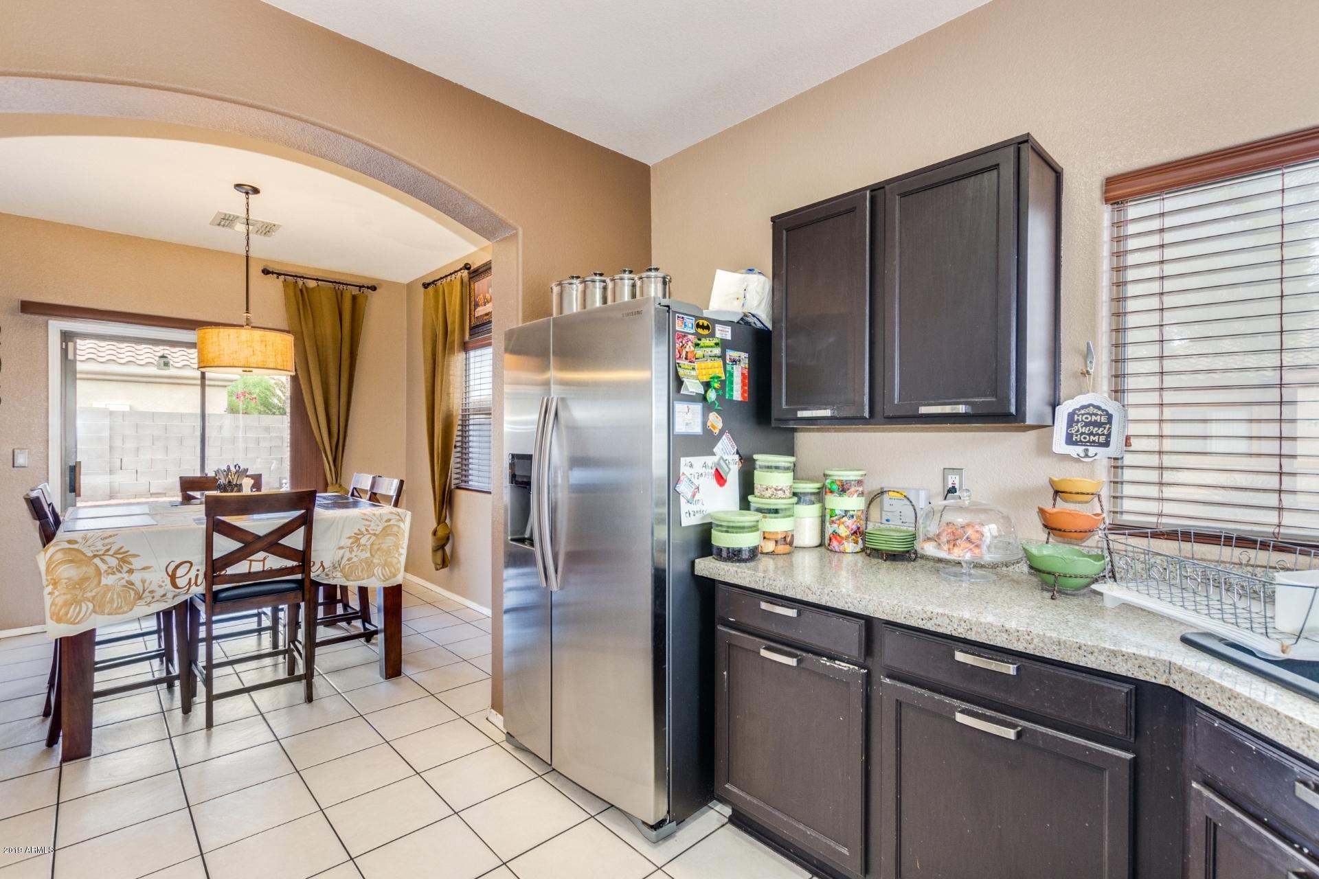 10434 East Bonnell Street Apache Junction, AZ 85120 - Photo 9 of 21 a kitchen with stainless steel appliances granite countertop a refrigerator and a sink