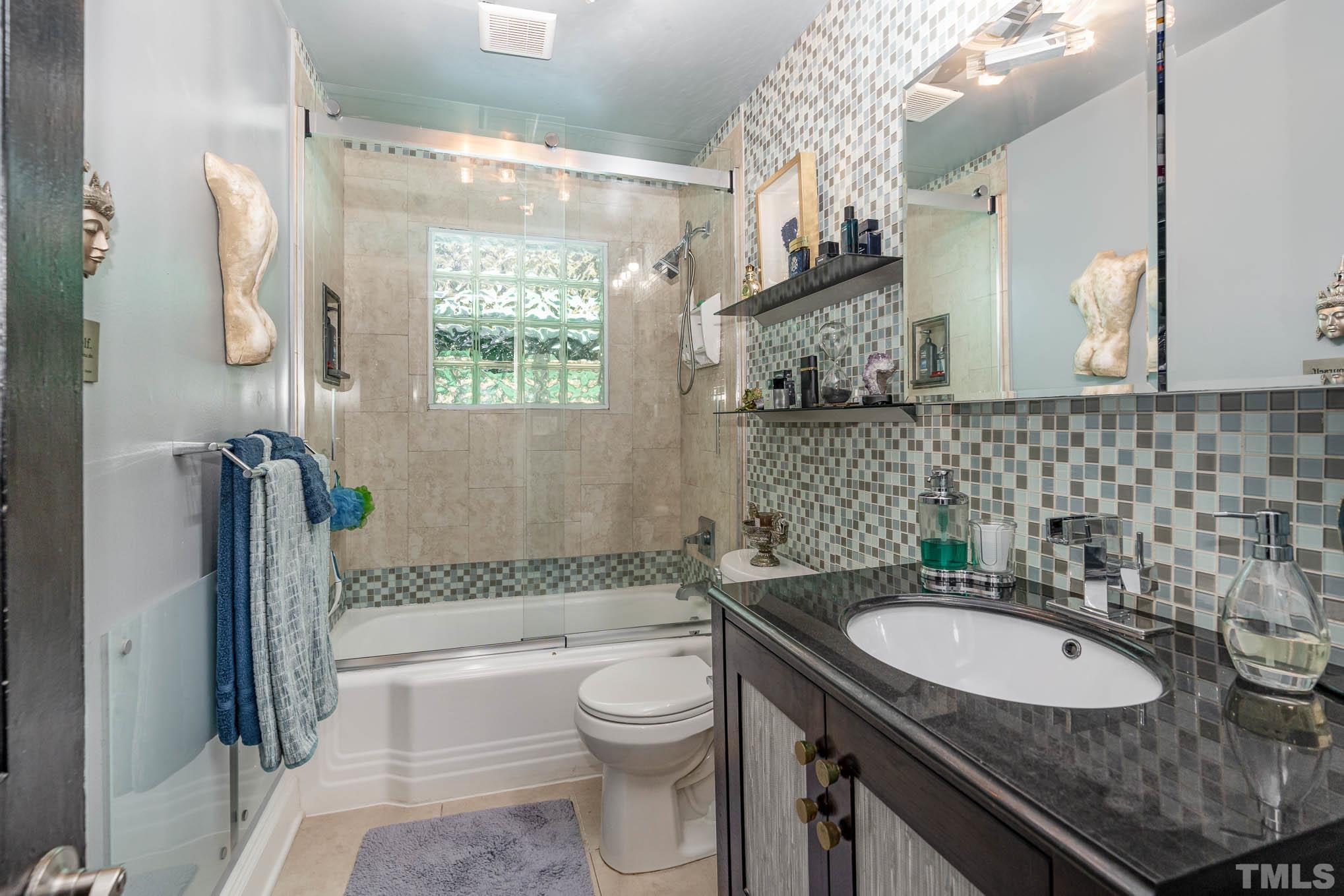 2738 Newbold Street Raleigh, NC 27603 - Photo 11 of 18 a bathroom with a granite countertop sink toilet and shower