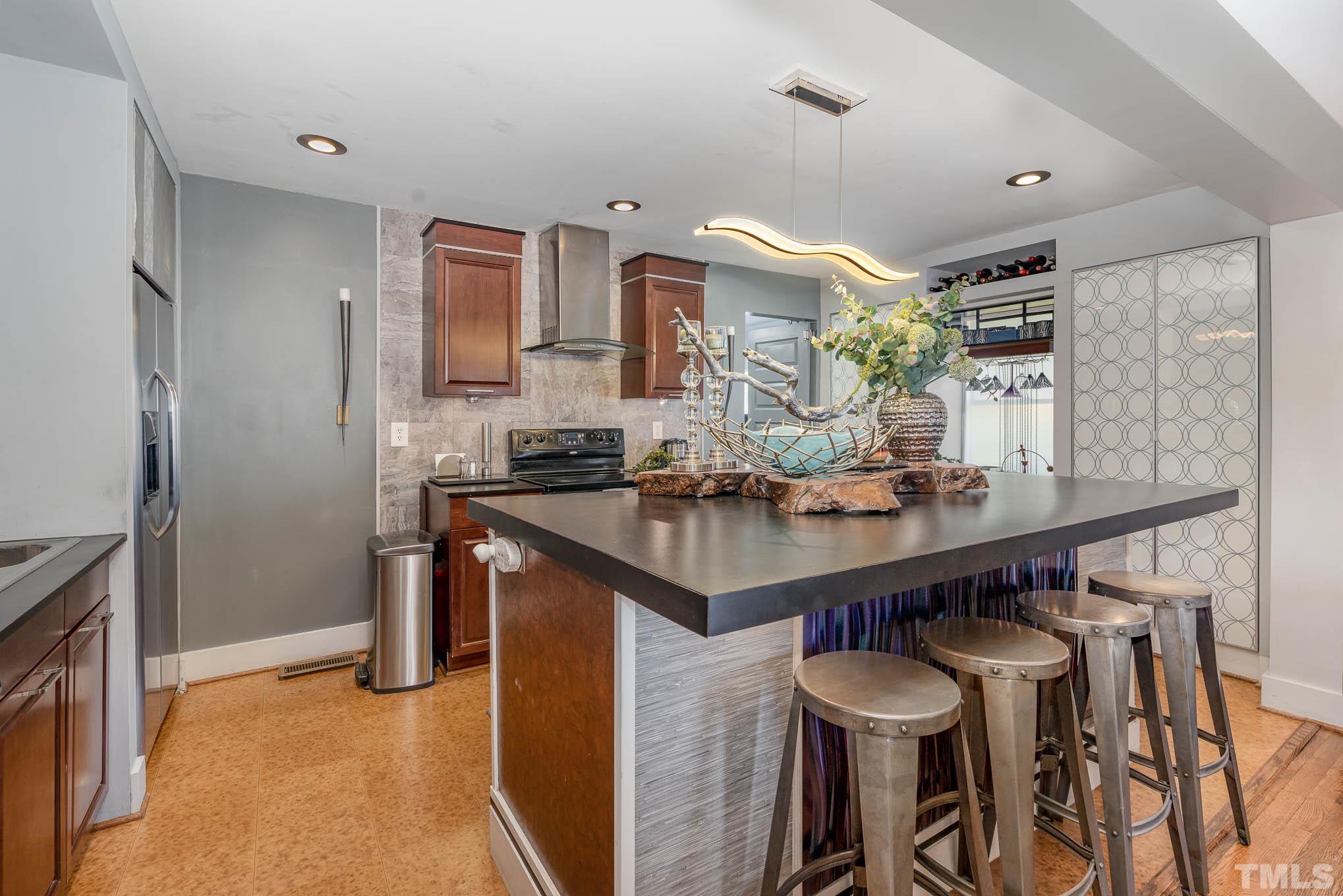 2738 Newbold Street Raleigh, NC 27603 - Photo 7 of 18 a kitchen with stainless steel appliances granite countertop a sink and a refrigerator