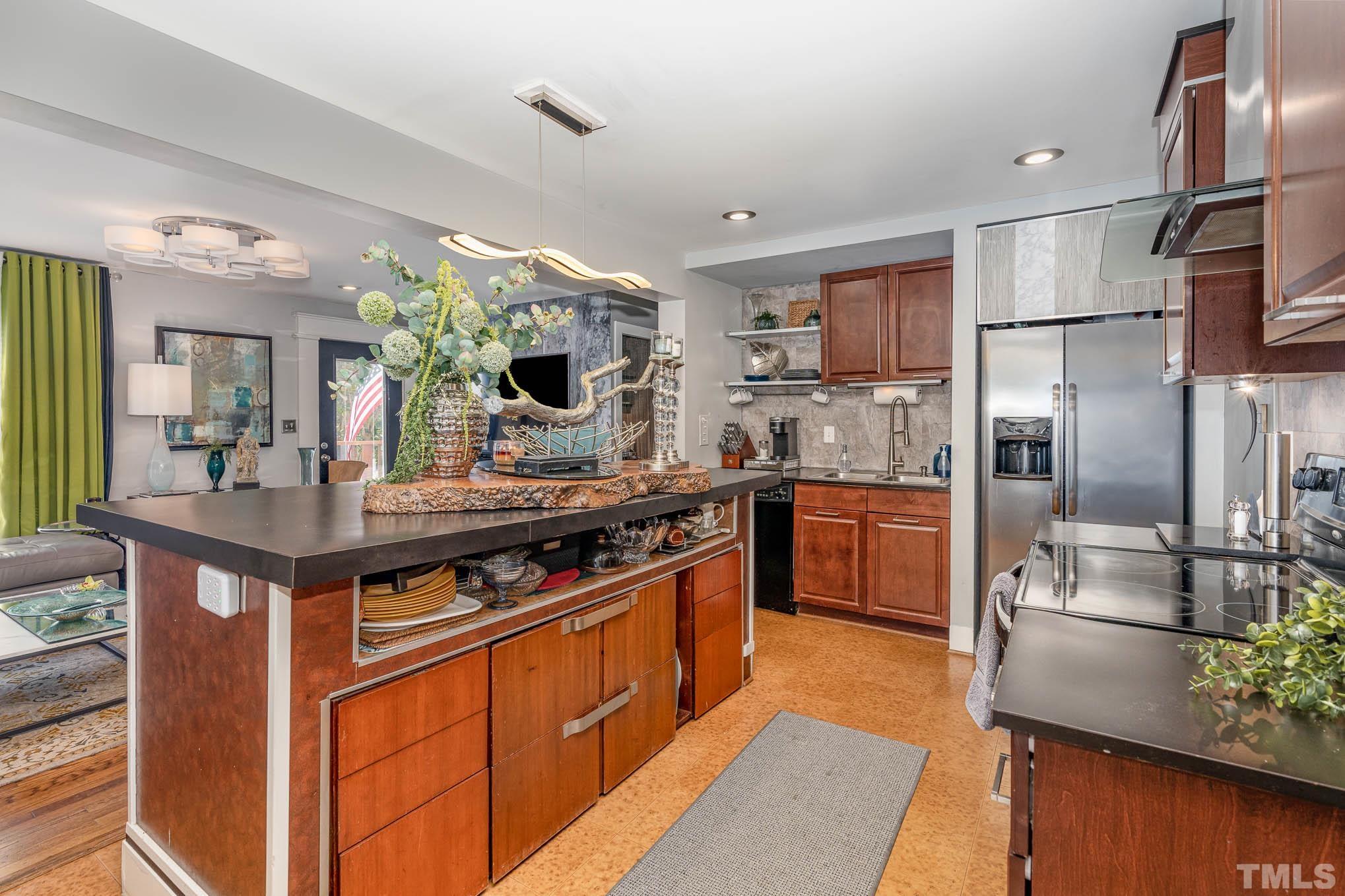 2738 Newbold Street Raleigh, NC 27603 - Photo 9 of 18 a kitchen with stainless steel appliances a sink stove and refrigerator