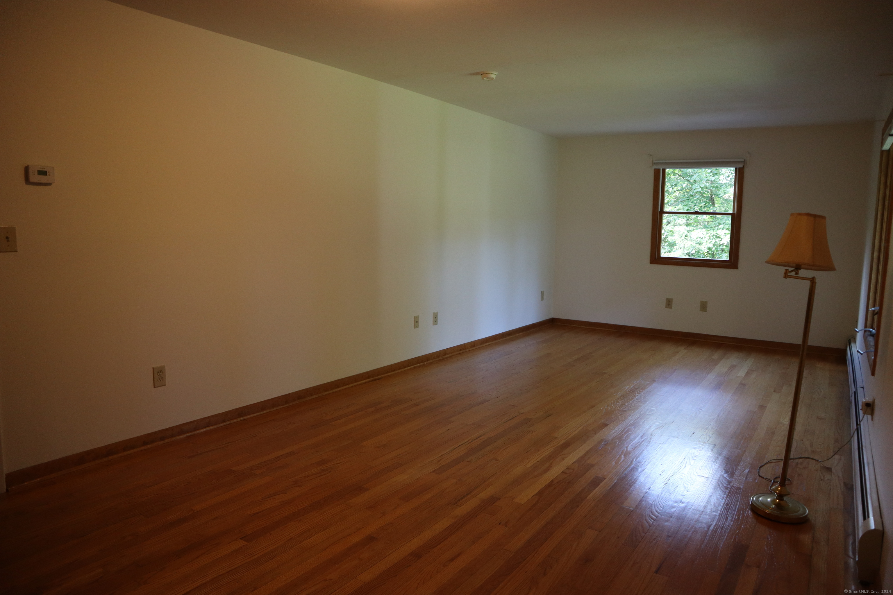 151 Chestnut Ridge Road Bethel, CT 06801 - Photo 12 of 23 an empty room with wooden floor and windows