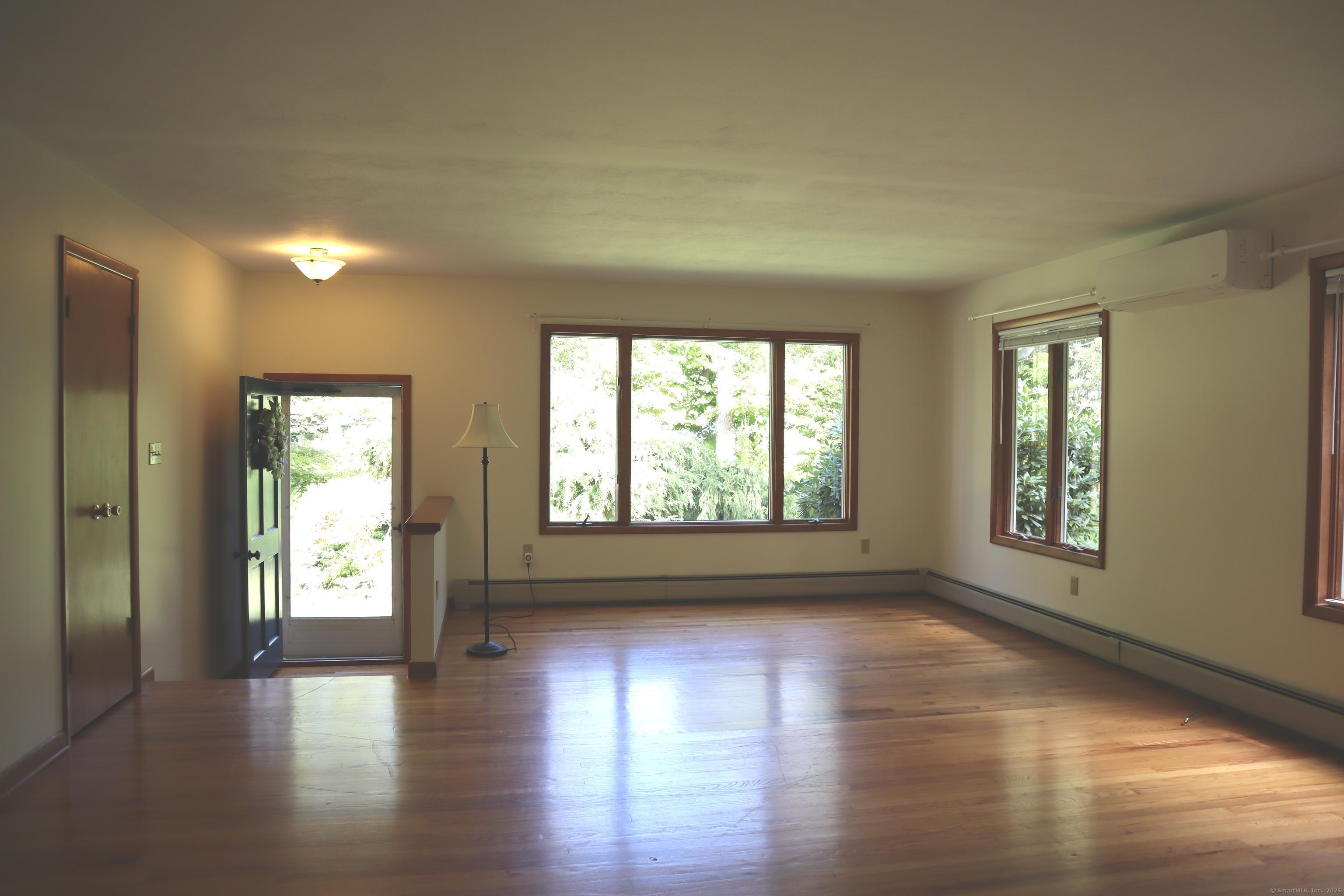 151 Chestnut Ridge Road Bethel, CT 06801 - Photo 5 of 23 a view of an empty room with wooden floor and a window
