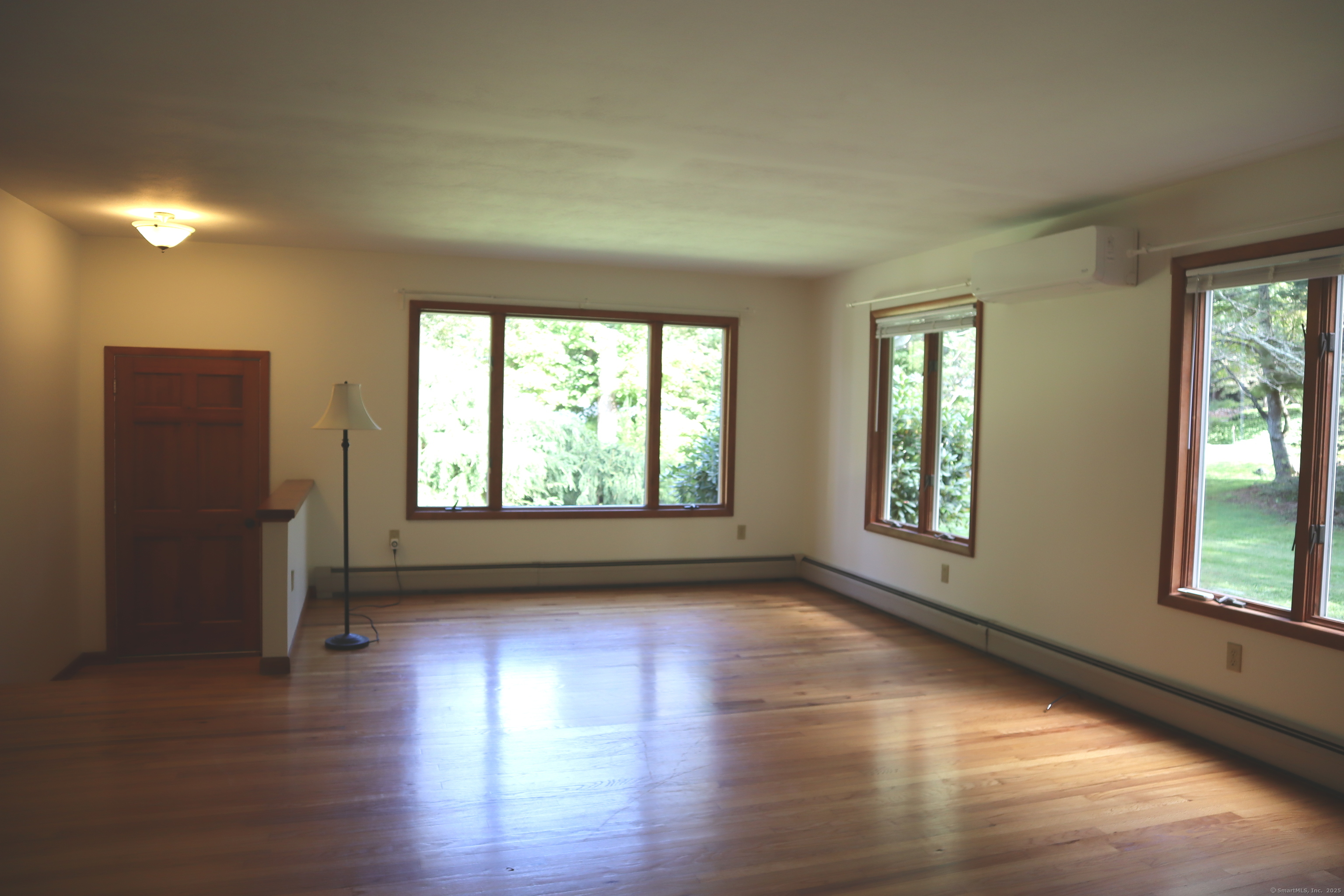 151 Chestnut Ridge Road Bethel, CT 06801 - Photo 6 of 23 an empty room with wooden floor and windows
