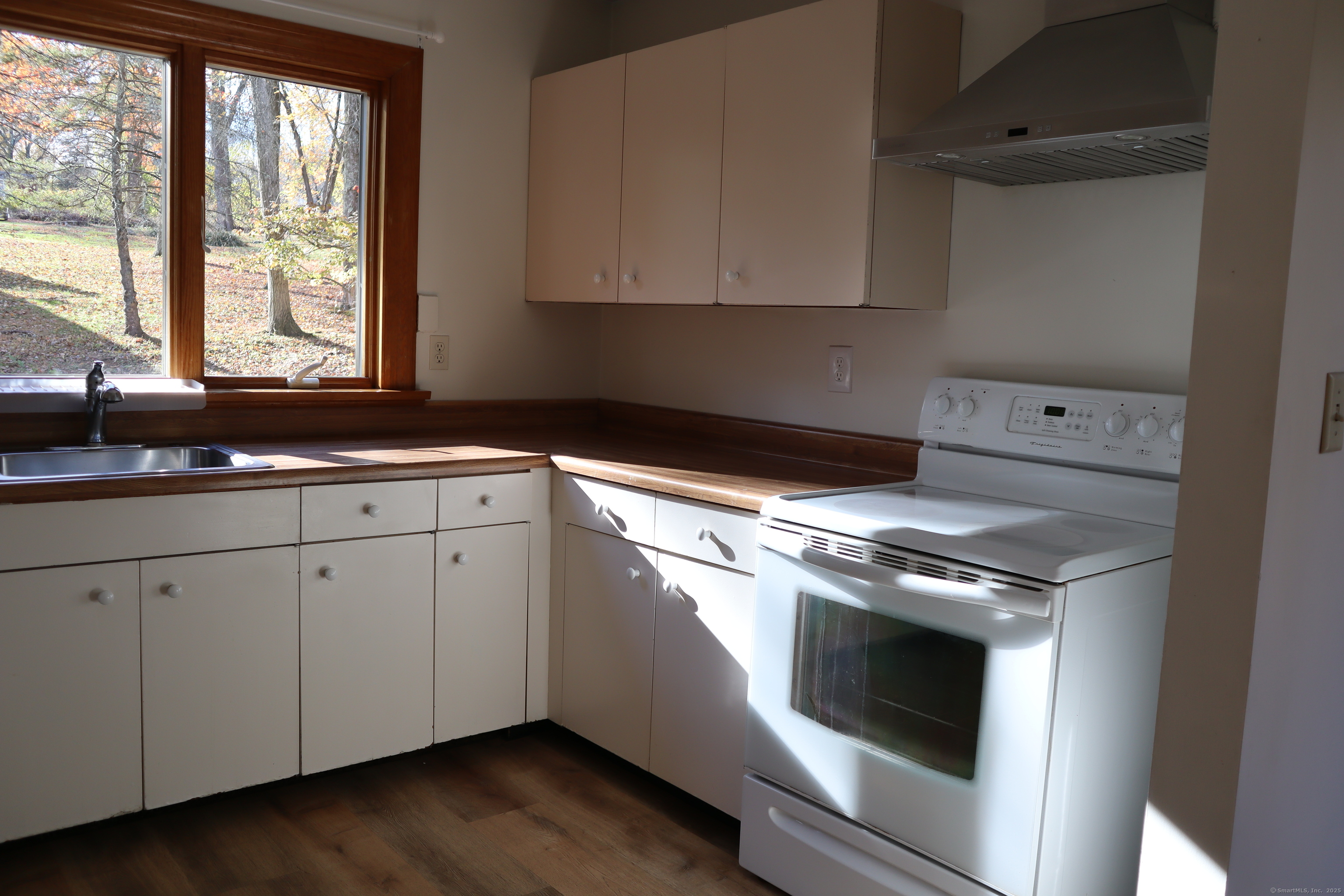151 Chestnut Ridge Road Bethel, CT 06801 - Photo 7 of 23 a kitchen with granite countertop white cabinets and white appliances