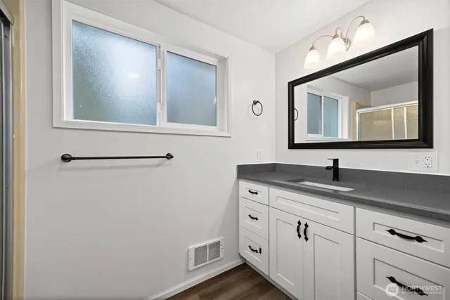 a view of a hallway with wooden floor and closet