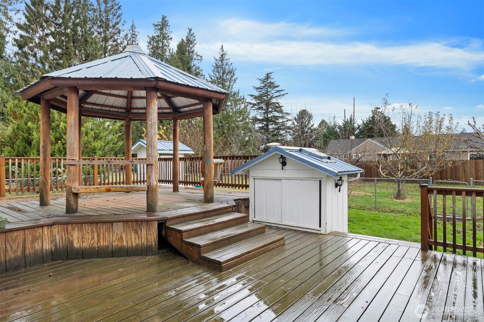 21275 Lafayette Road Sedro-Woolley, WA 98284 - Photo 34 of 40 a view of a roof deck with couches with wooden floor and fence