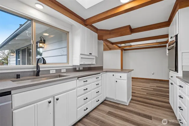 a spacious bathroom with double sink and a mirror