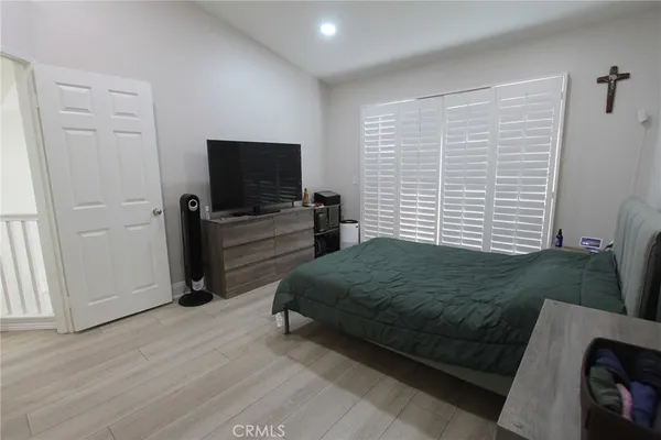 a bedroom with a bed and a television