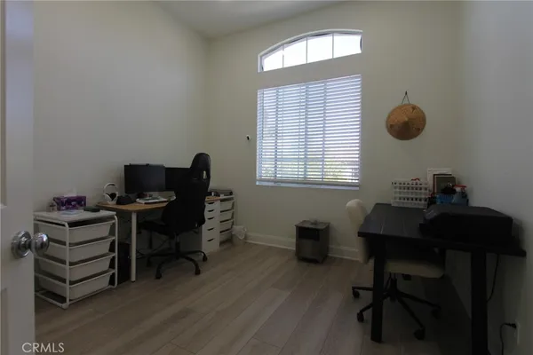 a view of a workspace with furniture and a window