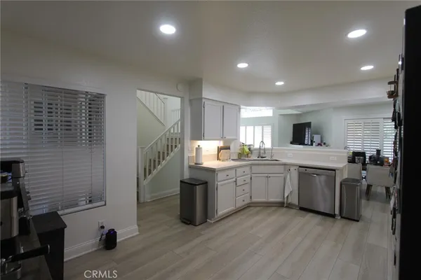 a kitchen with cabinets and wooden floor