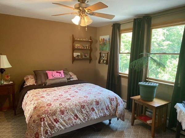 70 Cutler Road Holden, MA 01522 - Photo 22 of 28 a bedroom with a bed and a chandelier