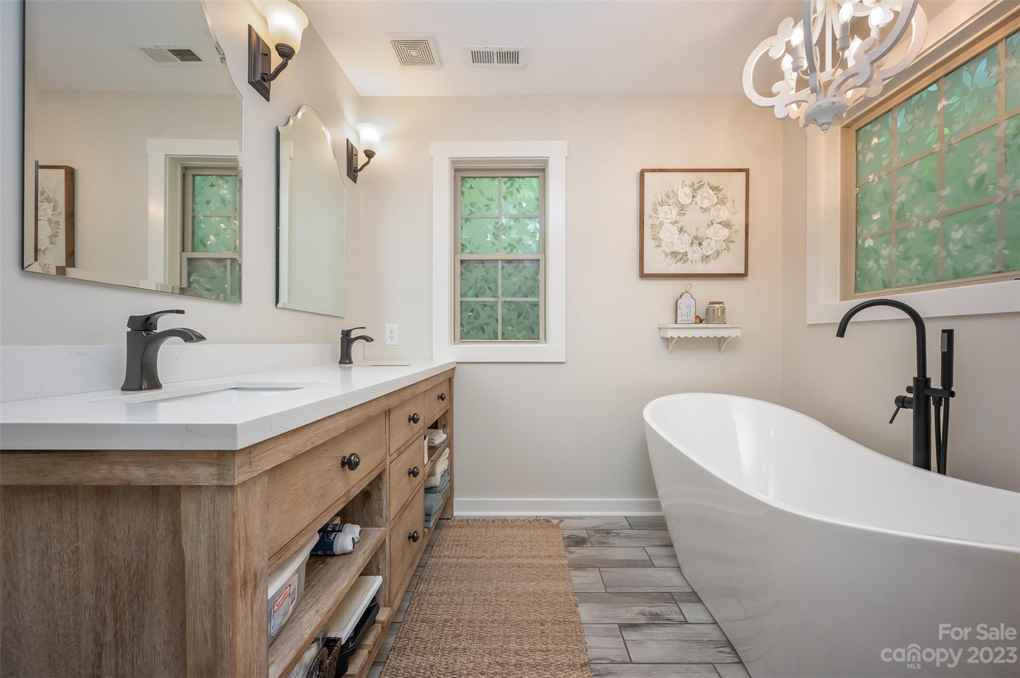 280 Cherokee Circle Tryon, NC 28782 - Photo 15 of 38 a bathroom with a double vanity sink a mirror and a bathtub