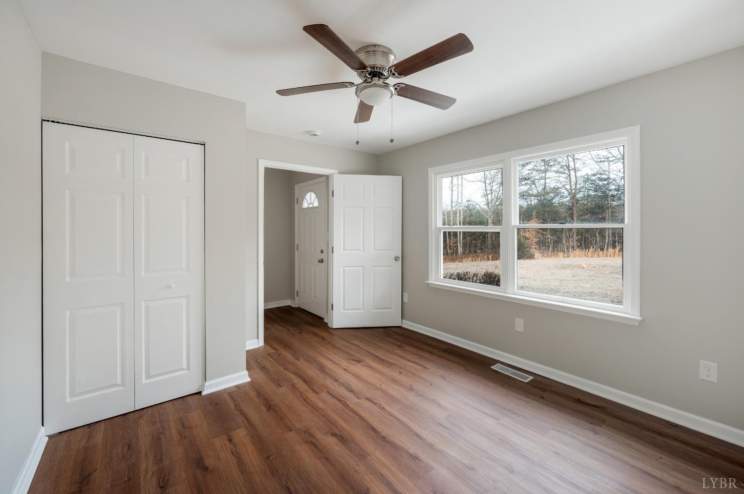 1784 Lukin Road Pamplin, VA 23958 - Photo 14 of 31 a view of an empty room with a window and wooden floor