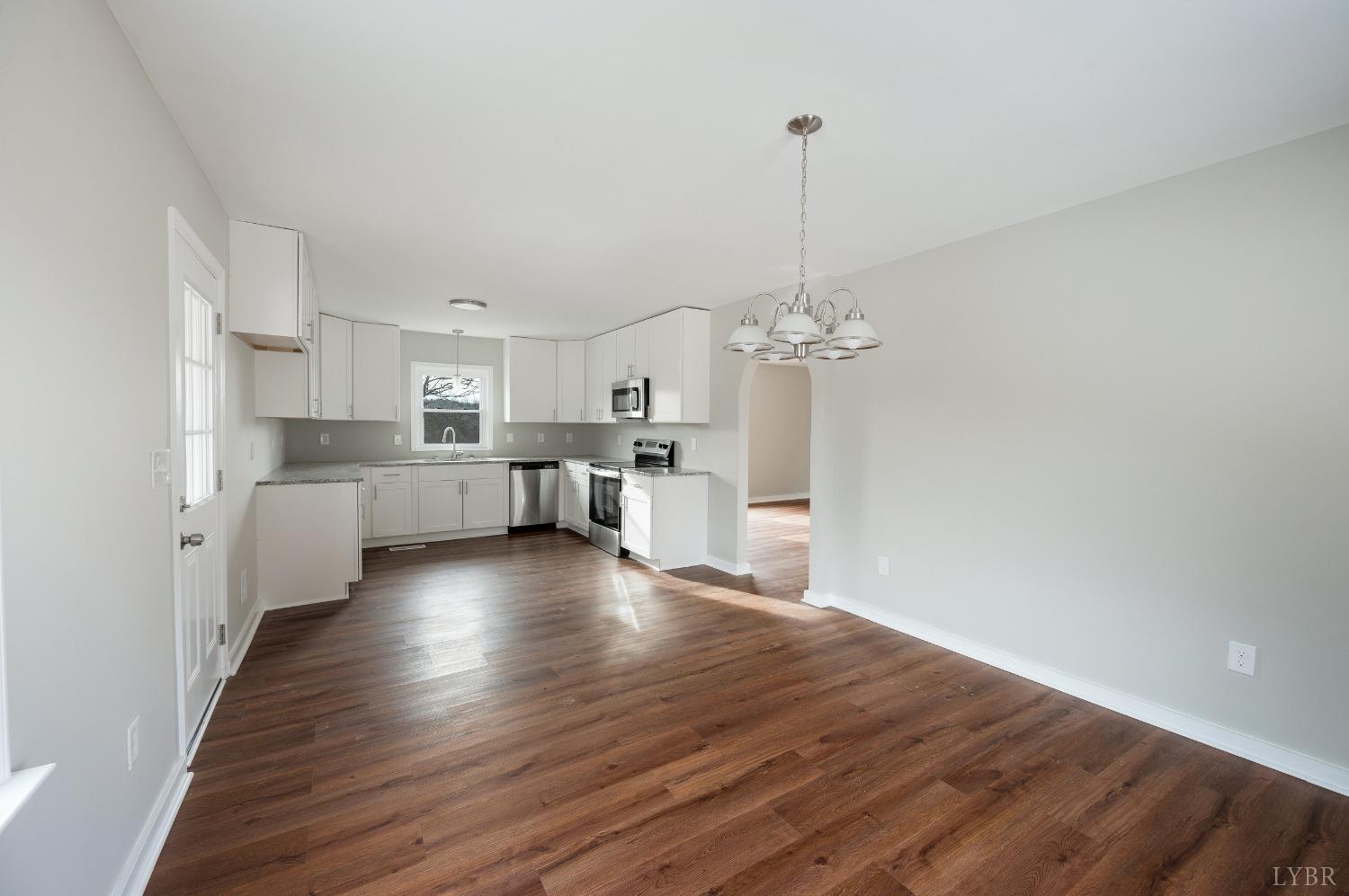1784 Lukin Road Pamplin, VA 23958 - Photo 18 of 31 a view of a kitchen with stove and wooden floor