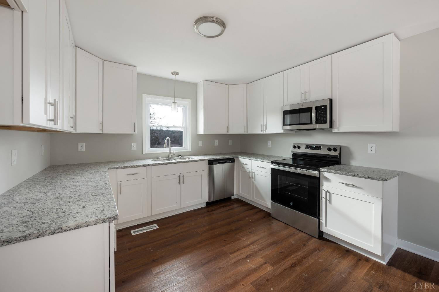 1784 Lukin Road Pamplin, VA 23958 - Photo 19 of 31 a kitchen with granite countertop a sink cabinets and stainless steel appliances