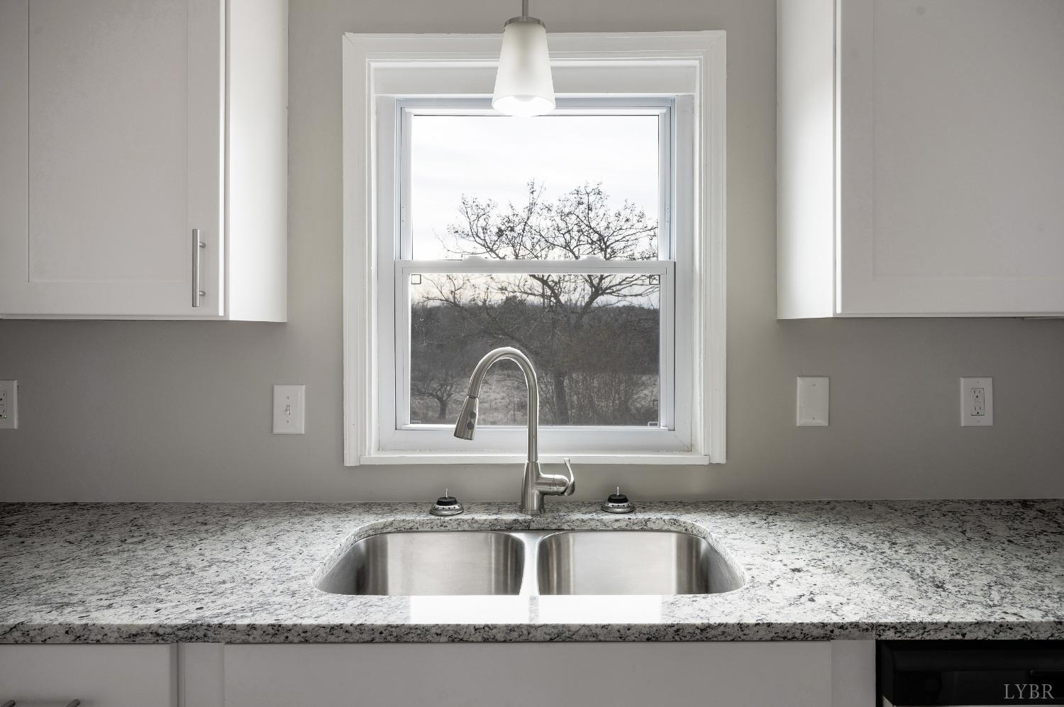 1784 Lukin Road Pamplin, VA 23958 - Photo 21 of 31 a kitchen with granite countertop a sink window and cabinets