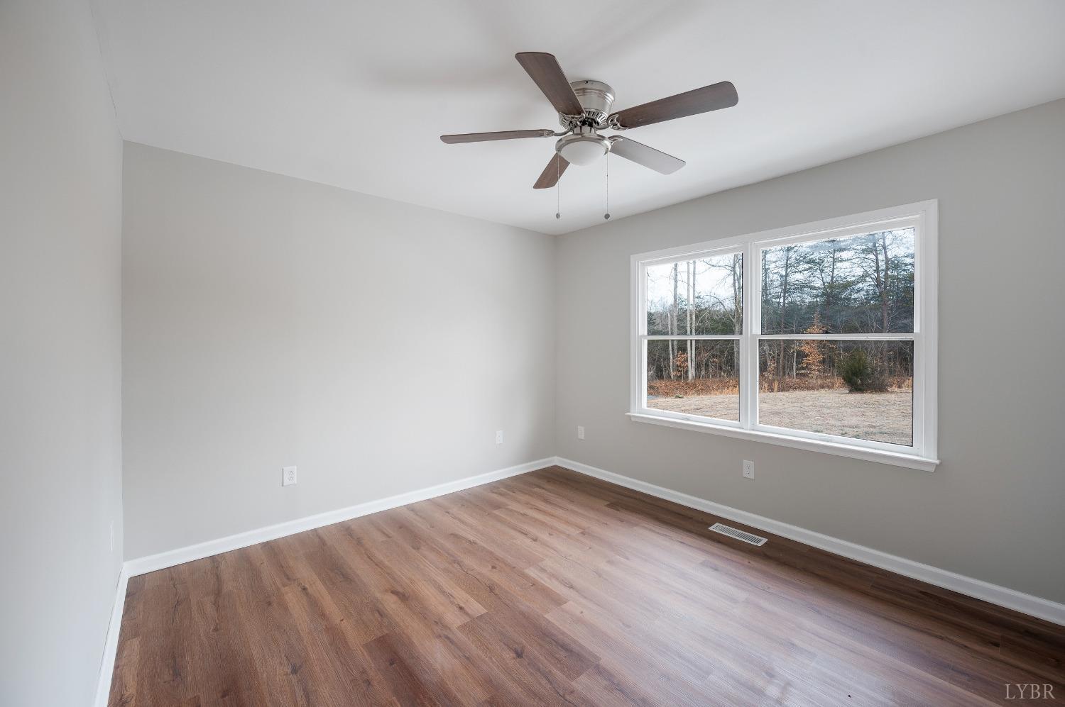 1784 Lukin Road Pamplin, VA 23958 - Photo 24 of 31 a view of a big room with wooden floor and windows in a room