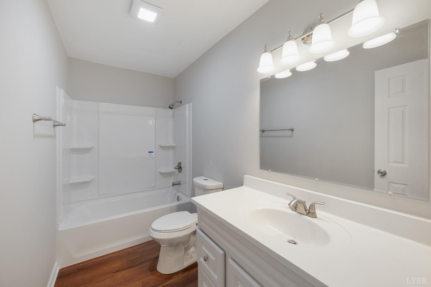 1784 Lukin Road Pamplin, VA 23958 - Photo 26 of 31 a bathroom with a toilet a sink a mirror a bathtub and shower