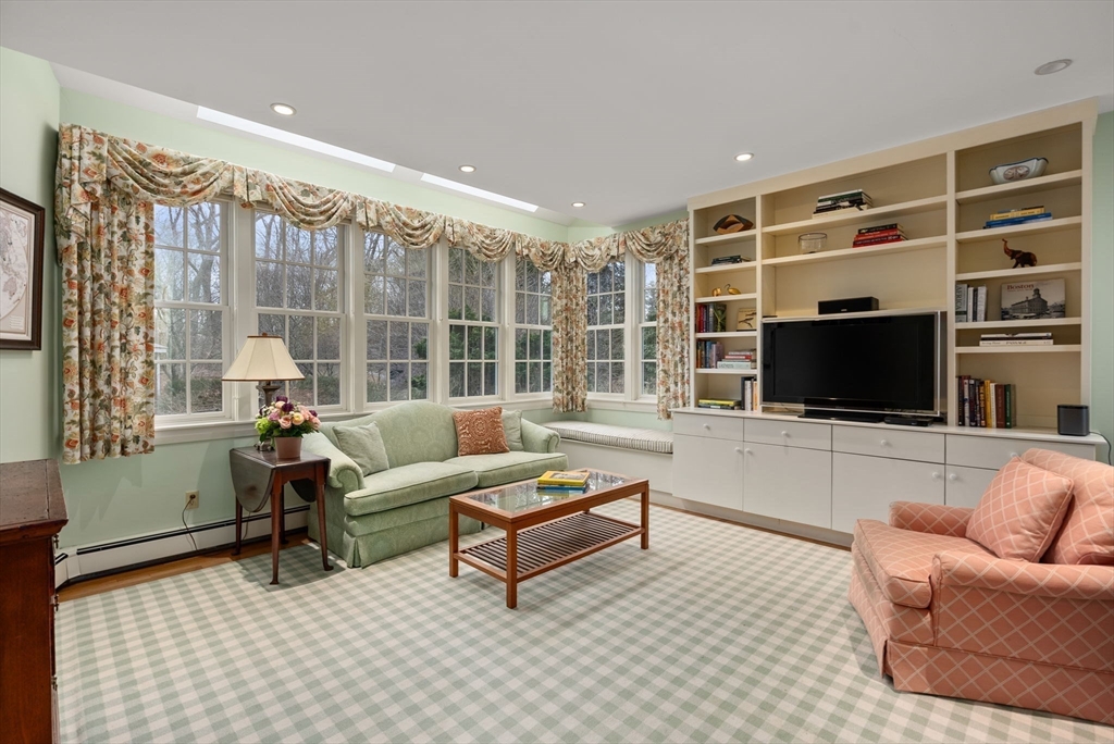 647 Boston Post Road Weston, MA 02493 - Photo 6 of 30 a living room with furniture a flat screen tv and a large window