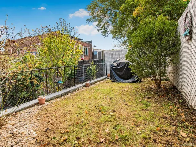 a view of a backyard with sitting area
