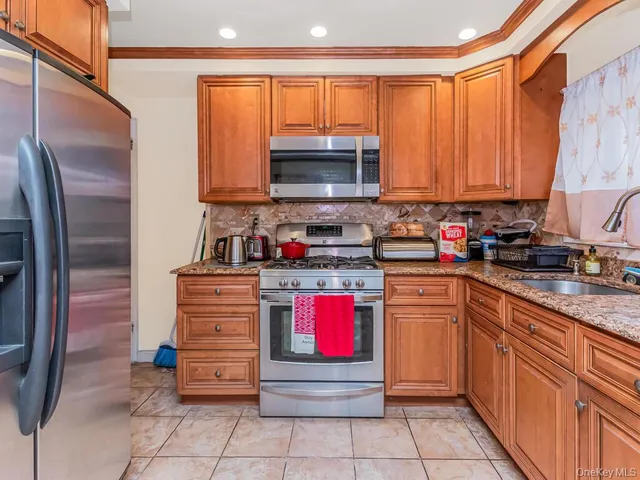 a kitchen with stainless steel appliances granite countertop a stove sink and cabinets