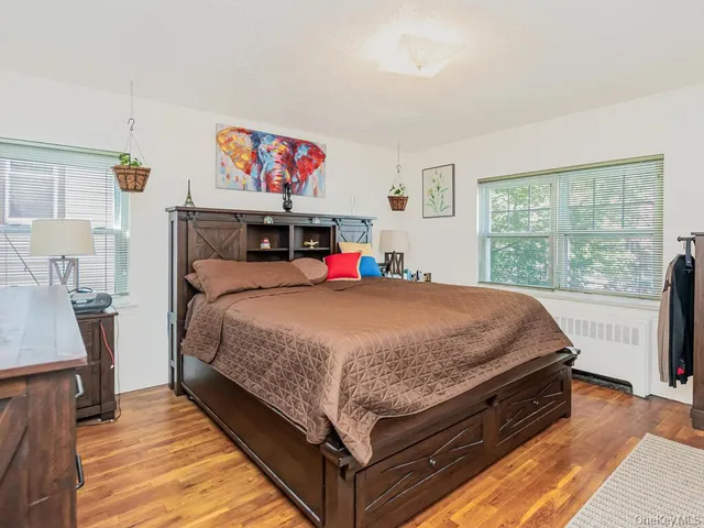 a bed sitting in a bedroom next to a window