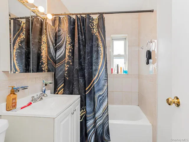 a bathroom with a sink a mirror and a shower curtain