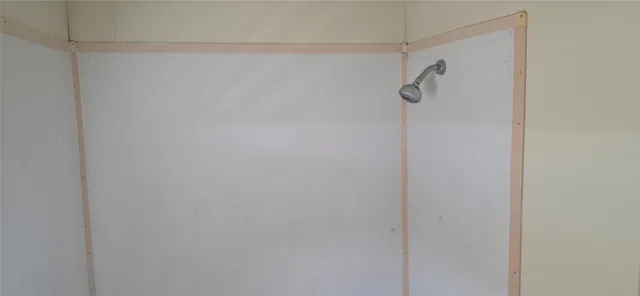 a view of a field with trees in background