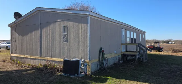 a backyard of a house with table and chairs