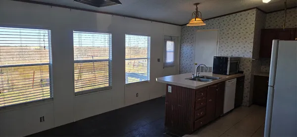 a bathroom with a shower and a ceiling fan