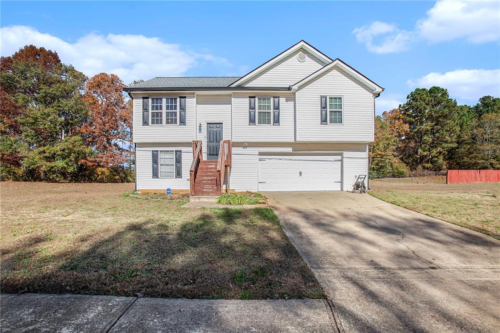 75 Thrasher Road Covington, GA 30016 - Photo 1 of 1 a front view of a house with a yard and garage