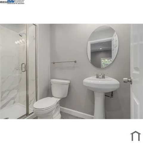 a bathroom with a sink toilet and a mirror