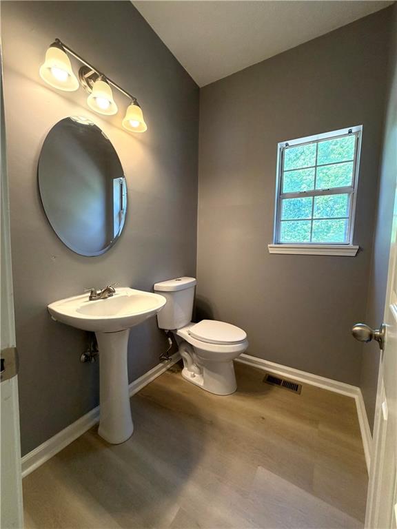 2205 Springer Walk Lawrenceville, GA 30043 - Photo 11 of 26 a bathroom with a toilet sink and mirror