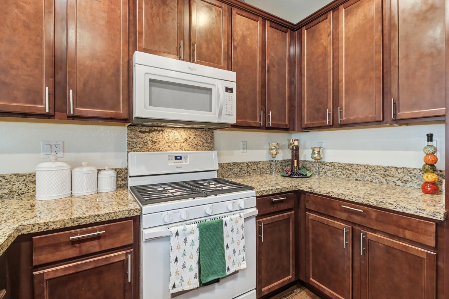 3215 Bridgeway Drive Rancho Cordova, CA 95670 - Photo 11 of 32 a kitchen with granite countertop cabinets stainless steel appliances and a sink