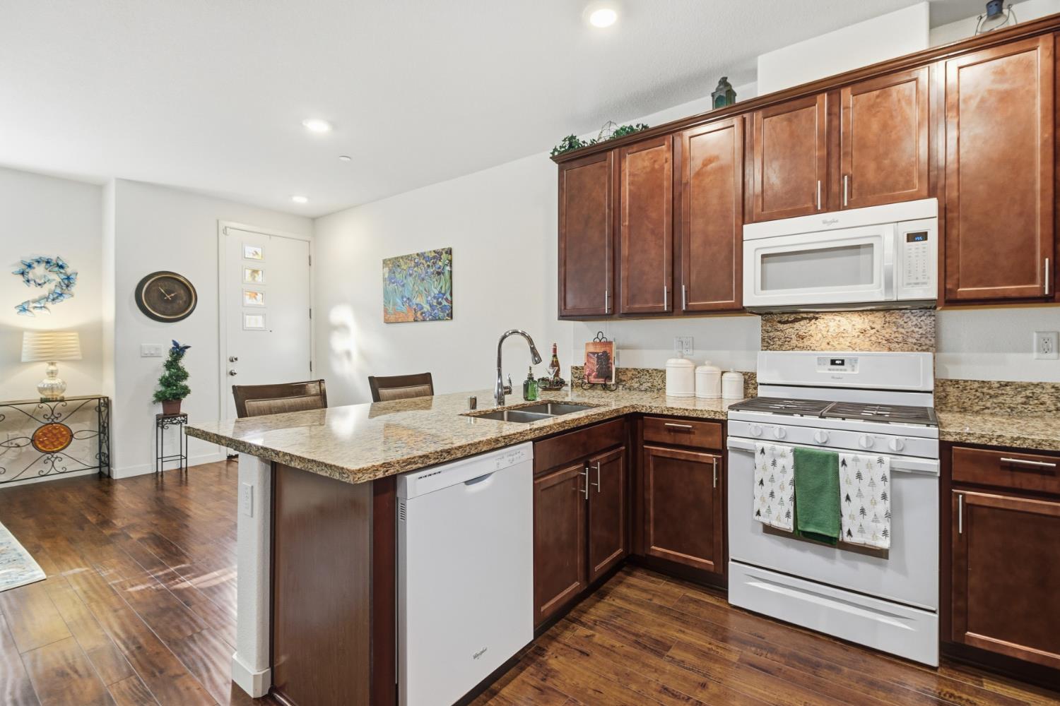 3215 Bridgeway Drive Rancho Cordova, CA 95670 - Photo 12 of 32 a kitchen with stainless steel appliances granite countertop a sink stove and cabinets