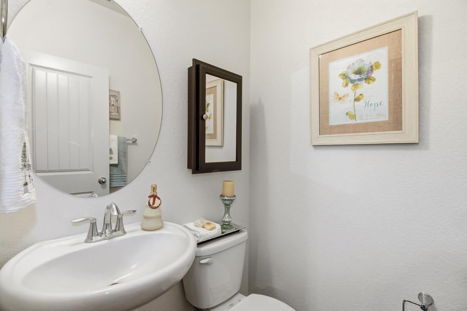 3215 Bridgeway Drive Rancho Cordova, CA 95670 - Photo 14 of 32 a bathroom with a toilet a sink and mirror