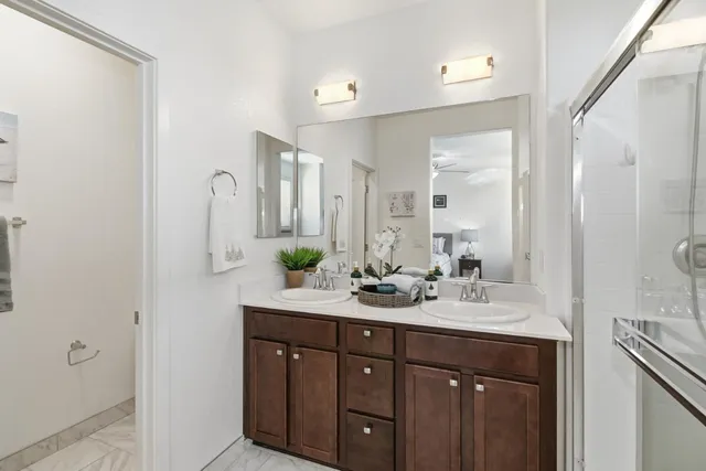 a bathroom with a double vanity sink mirror and double