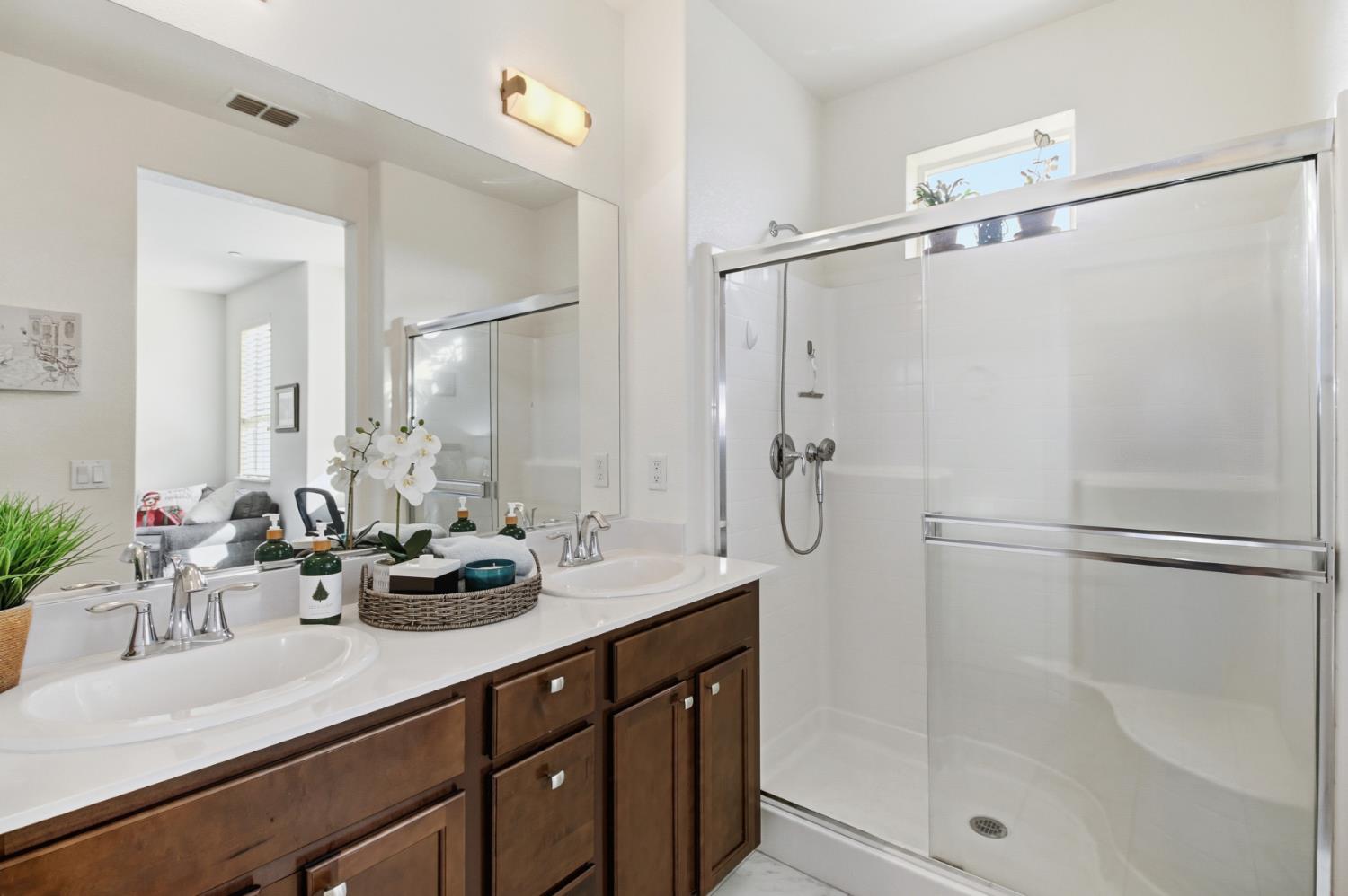 3215 Bridgeway Drive Rancho Cordova, CA 95670 - Photo 19 of 32 a bathroom with a double vanity sink mirror and shower