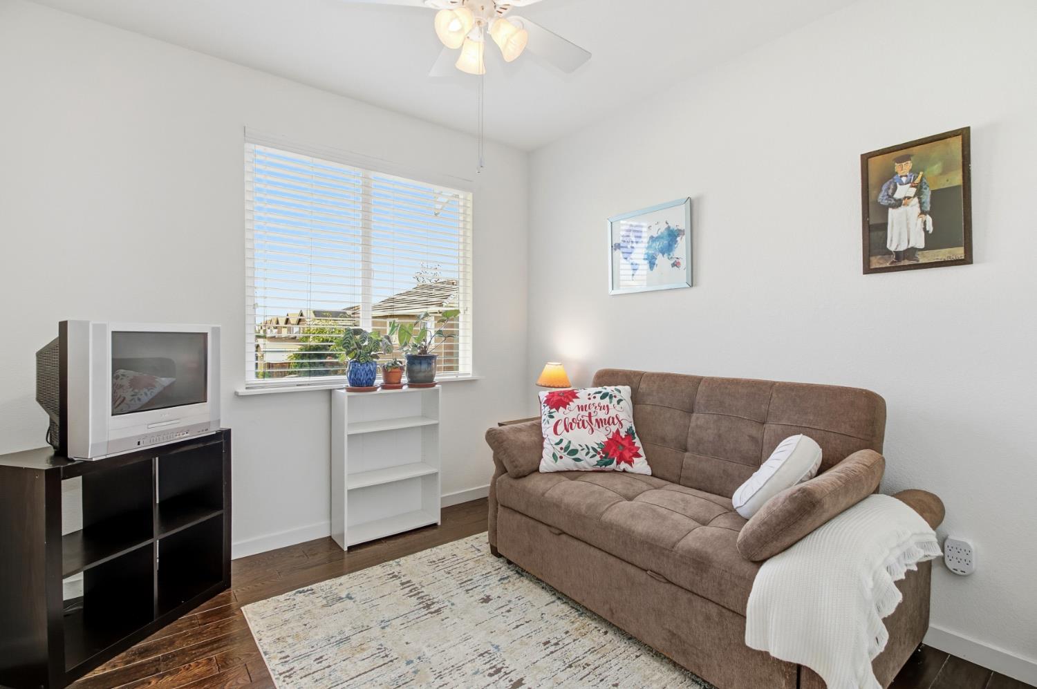 3215 Bridgeway Drive Rancho Cordova, CA 95670 - Photo 21 of 32 a living room with furniture and a flat screen tv
