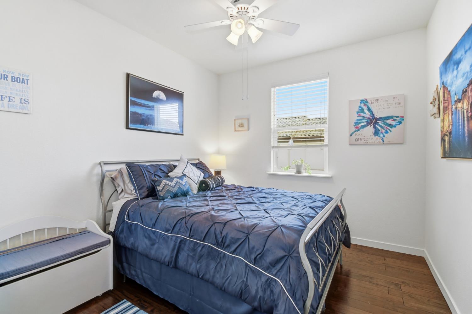 3215 Bridgeway Drive Rancho Cordova, CA 95670 - Photo 24 of 32 a bedroom with a bed and a chandelier