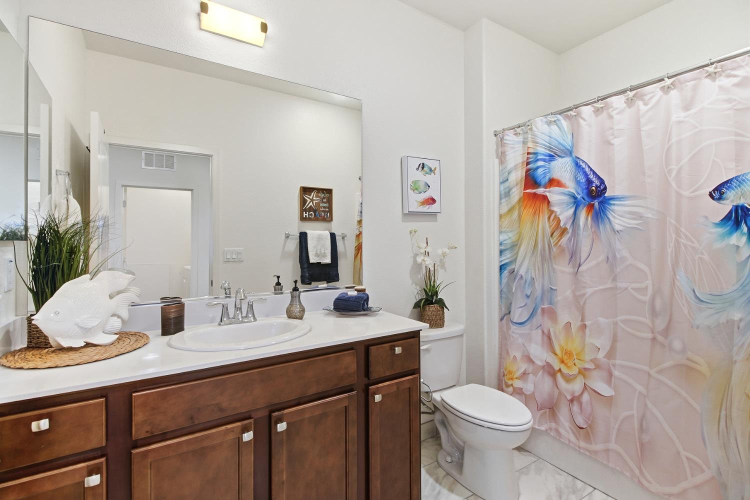 3215 Bridgeway Drive Rancho Cordova, CA 95670 - Photo 27 of 32 a bathroom with a granite countertop toilet sink and mirror