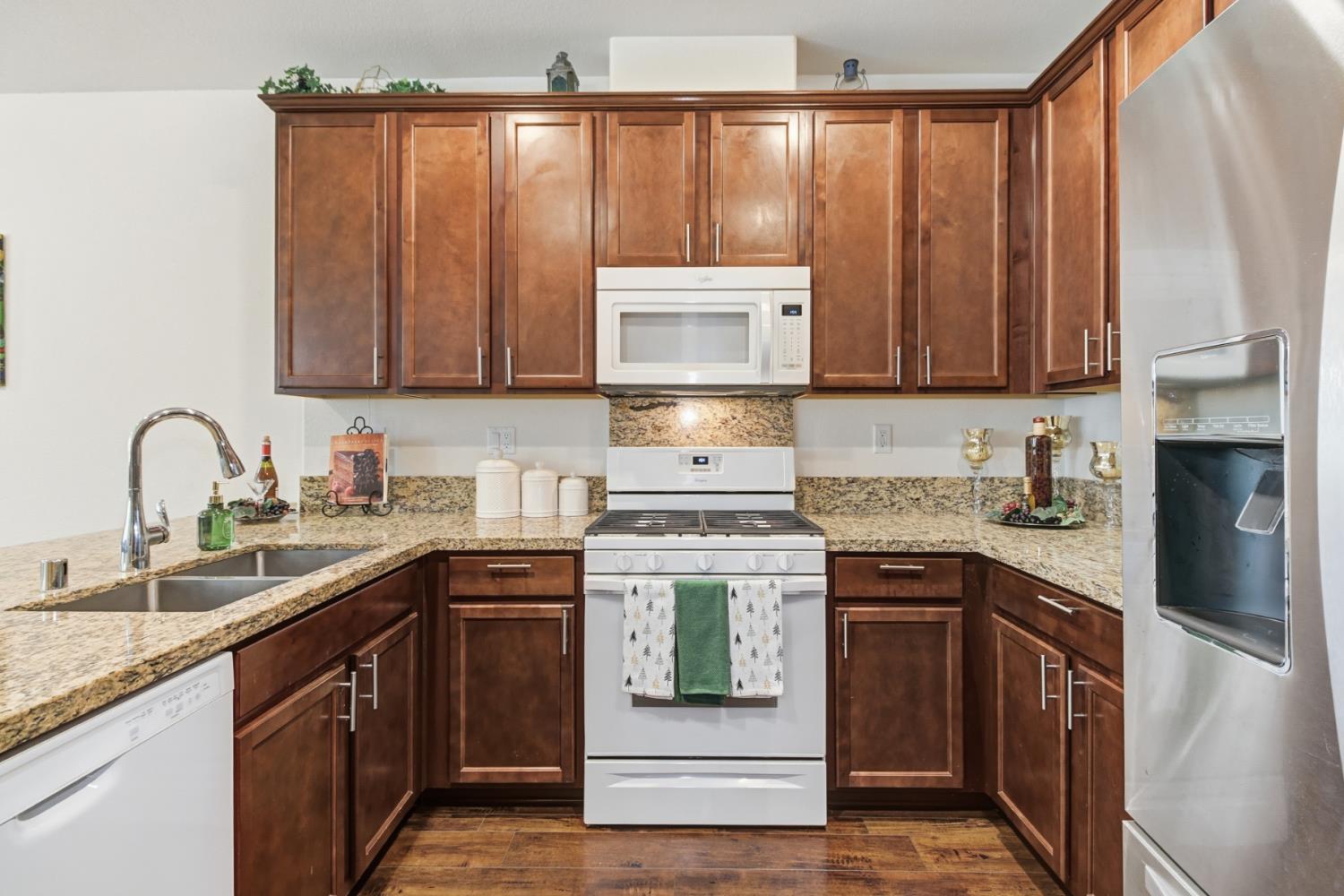3215 Bridgeway Drive Rancho Cordova, CA 95670 - Photo 9 of 32 a kitchen with stainless steel appliances granite countertop a stove sink and cabinets