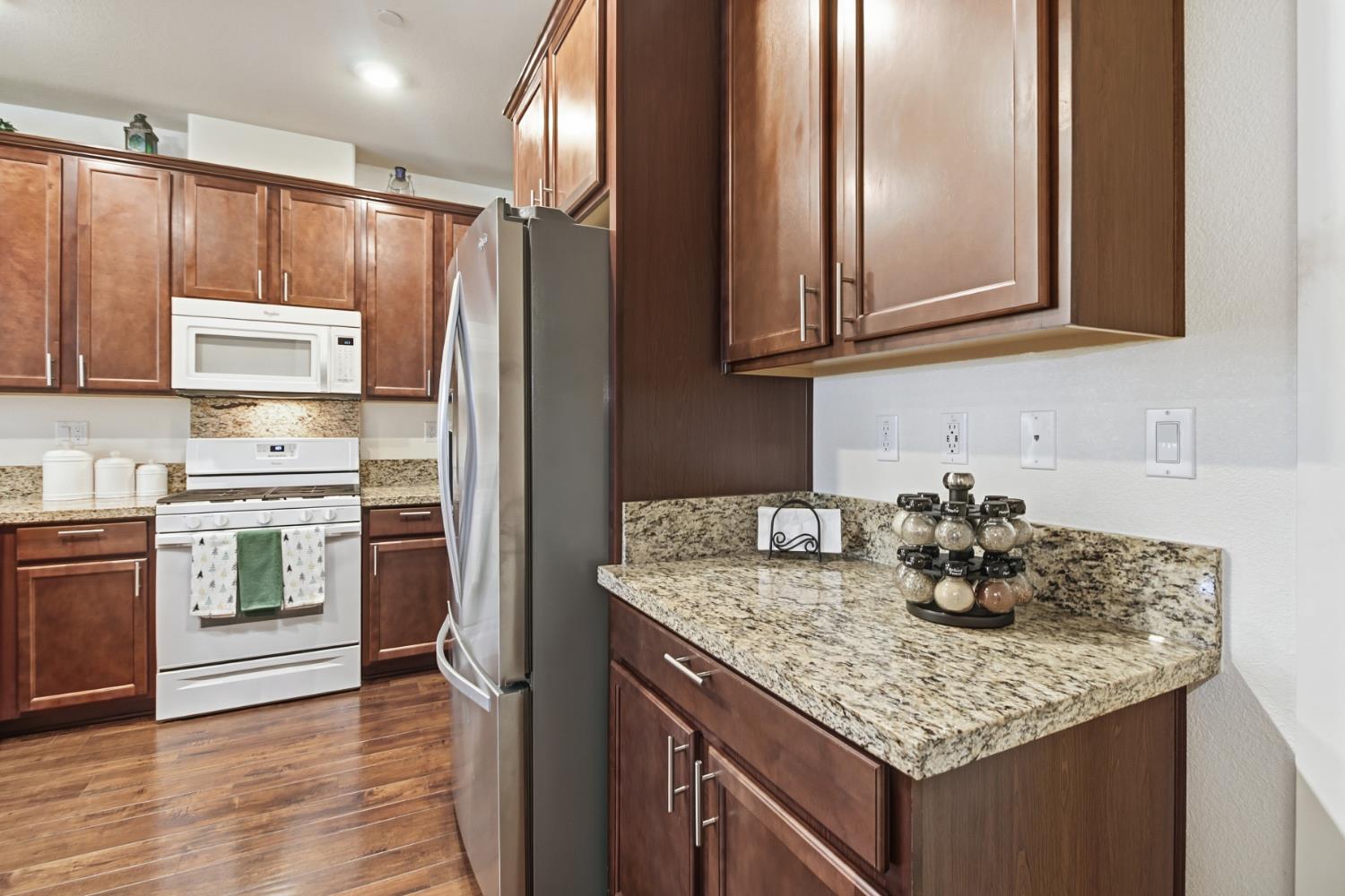 3215 Bridgeway Drive Rancho Cordova, CA 95670 - Photo 10 of 32 a kitchen with granite countertop a sink cabinets and stainless steel appliances