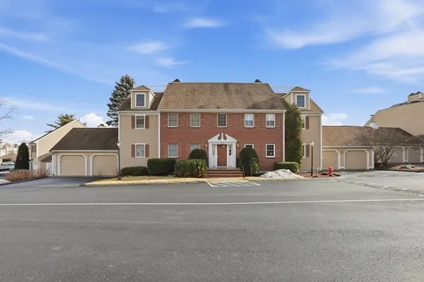 a front view of residential houses with a road