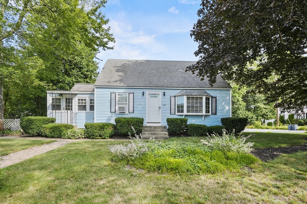 a front view of house with yard and green space
