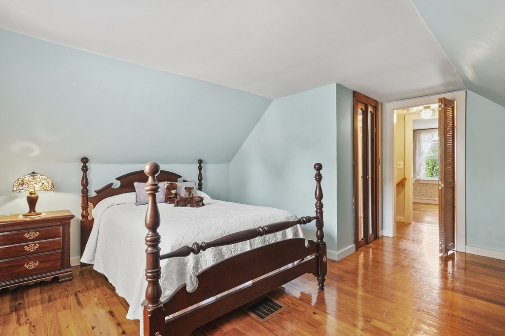 305 Whalom Road Lunenburg, MA 01462 - Photo 22 of 29 a bed sitting in a bedroom next to a window