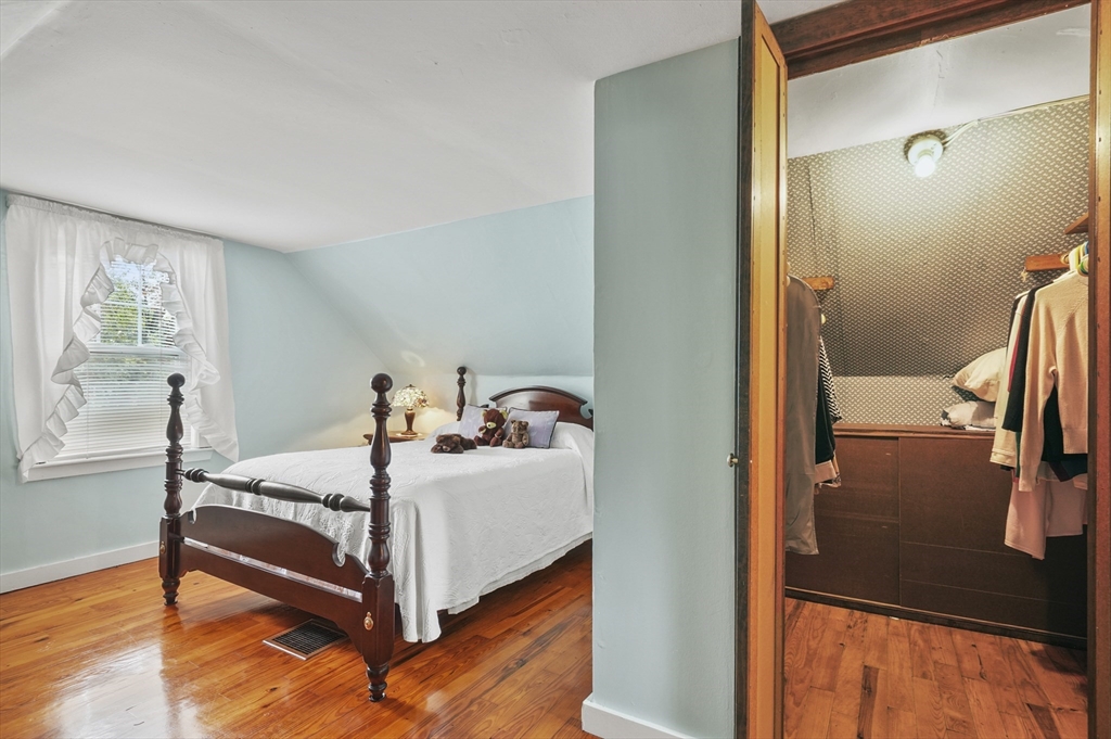 305 Whalom Road Lunenburg, MA 01462 - Photo 23 of 29 a bedroom with a bed and wooden floor
